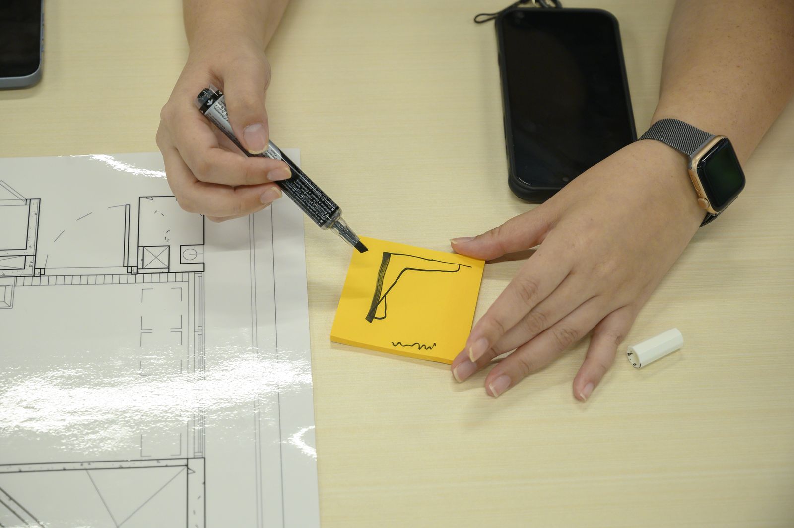 Drawing a furniture idea on a sticky note