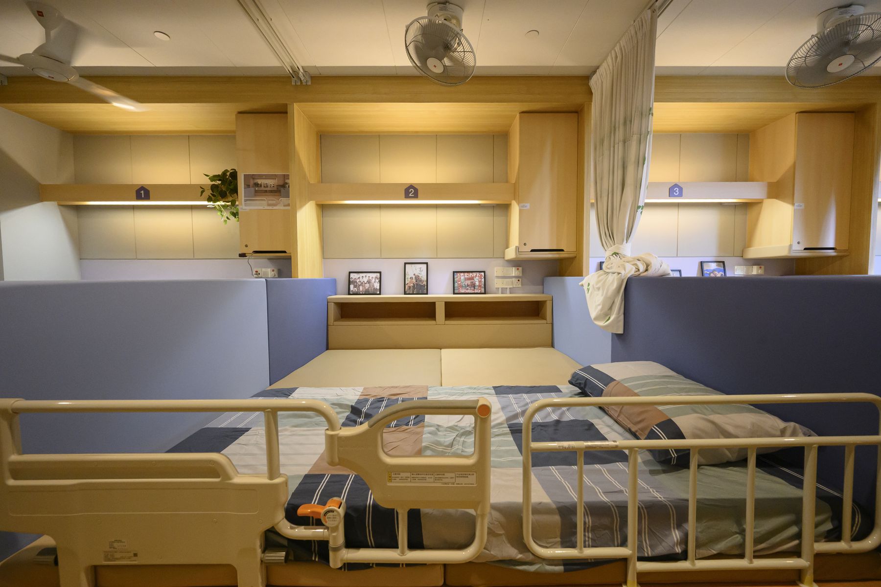 Wide view of a bay with the original bed alongside the new floor-based layout