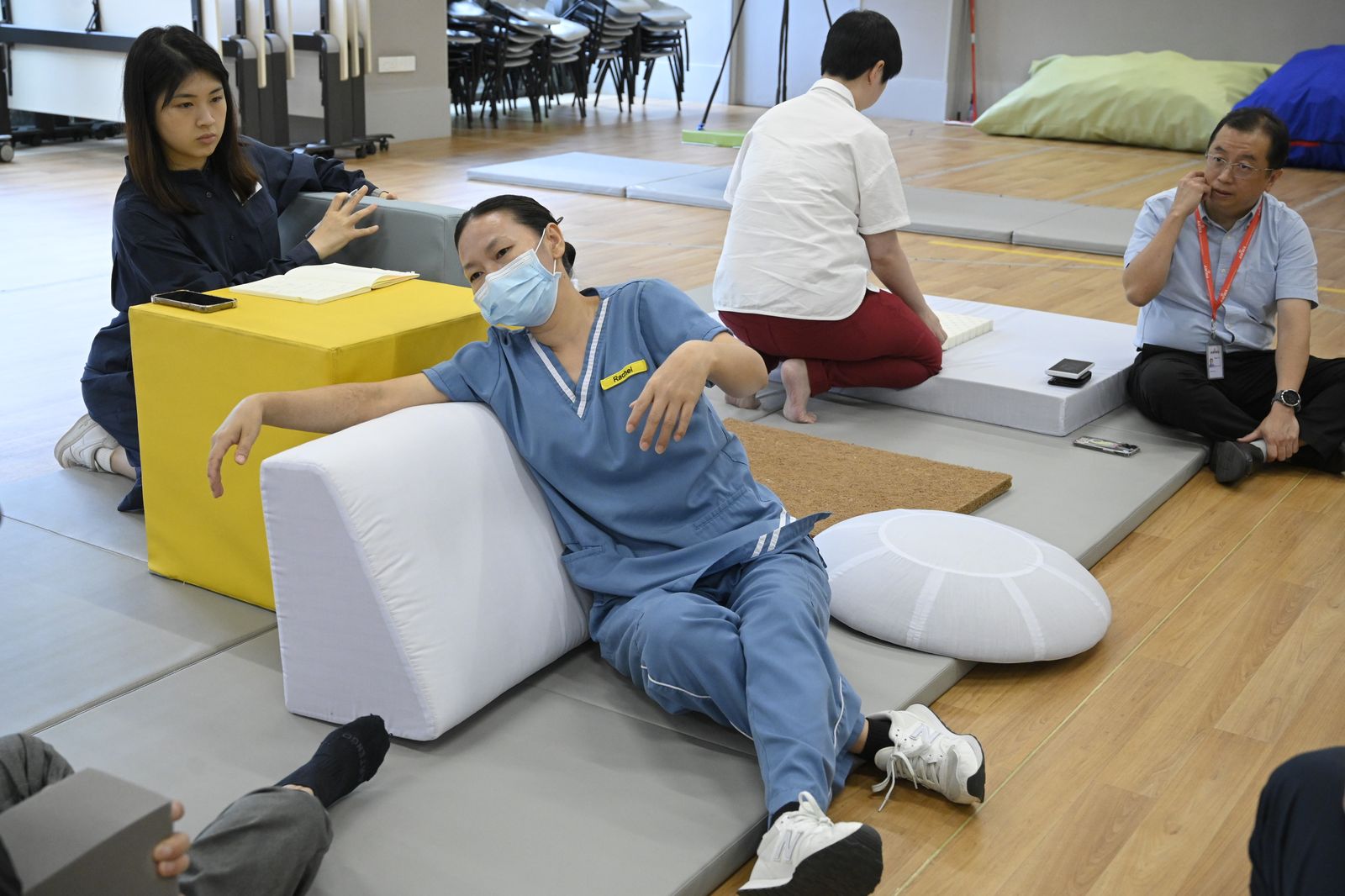 A nurse leaning back on a wedge cushion to test comfort