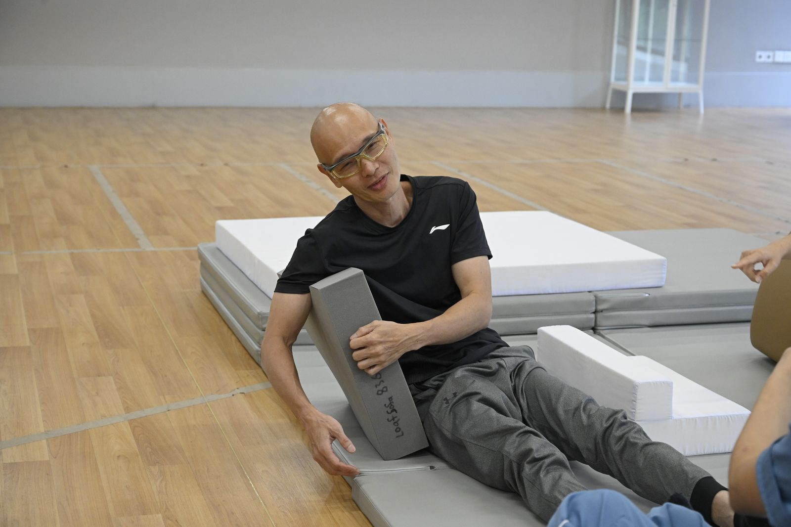 Testing a backrest block while sitting on the floor